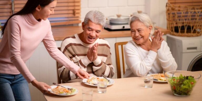 Elderly Couple Enjoying Home-Cooked Meal Together at Memory Care Facility