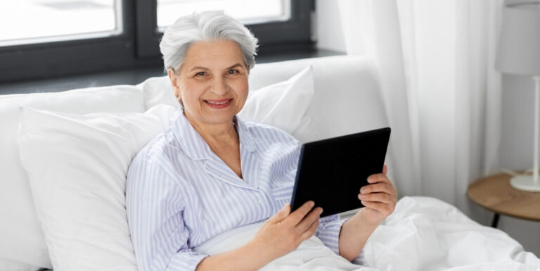 Elderly Woman Smiling with Tablet in Independent Living Apartment